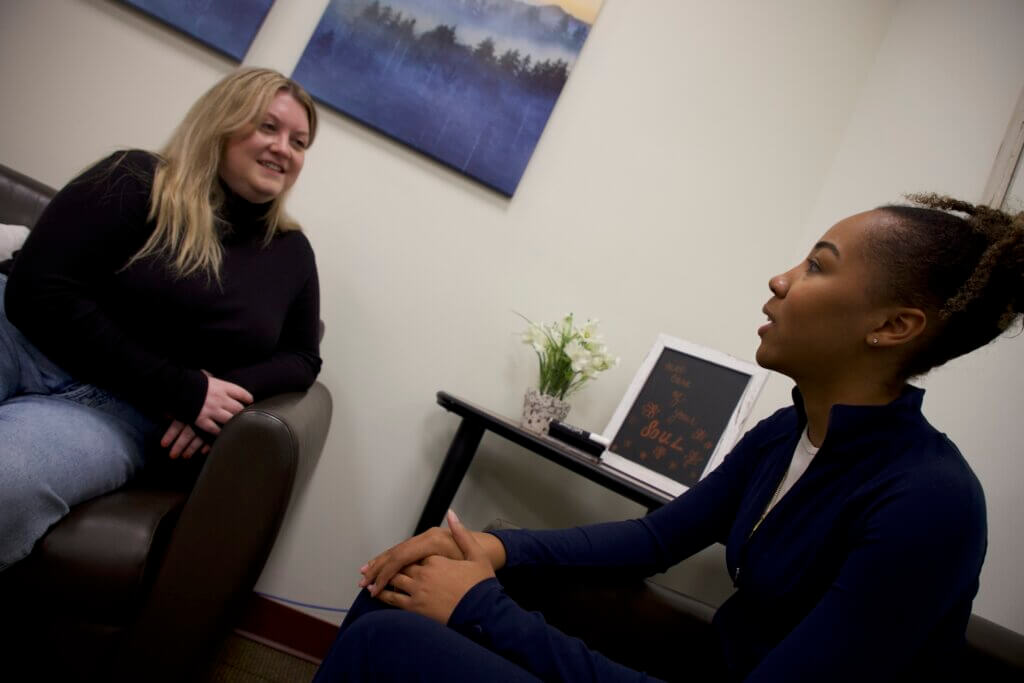 Woman talking to patient in lab