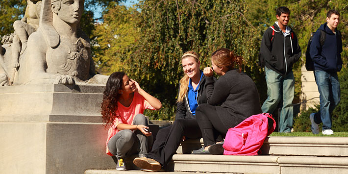 Students sitting on steps outside the Great Hall