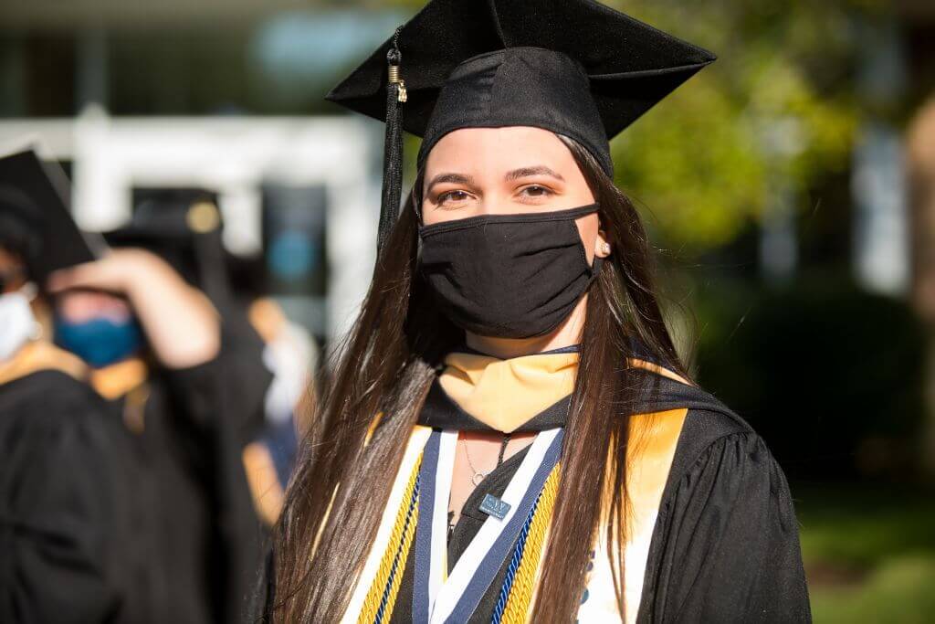 Woman with mask on at commencment