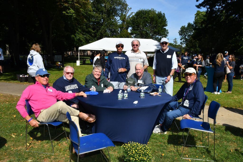 Alumni at a table on the Great Lawn