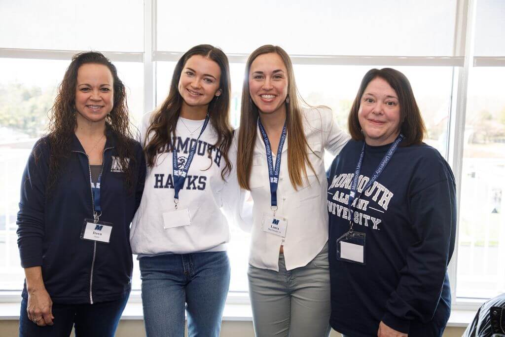 Four Wine vs. Stein participants posing for a photo, some in Monmouth spirit wear