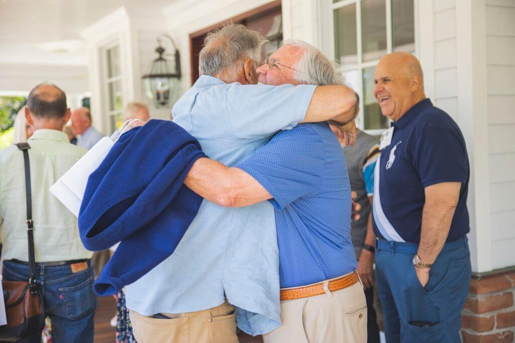 Two men hugging at Alumni Weekend 2022 Brunch