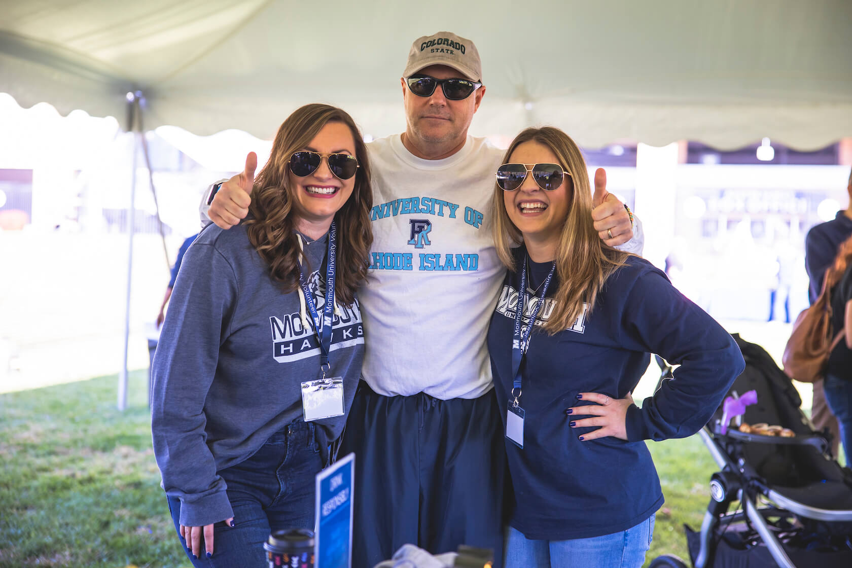 Monmouth and URI fans under the tent