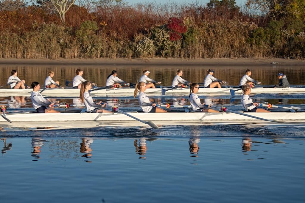 Athletes rowing their boats in a body of water