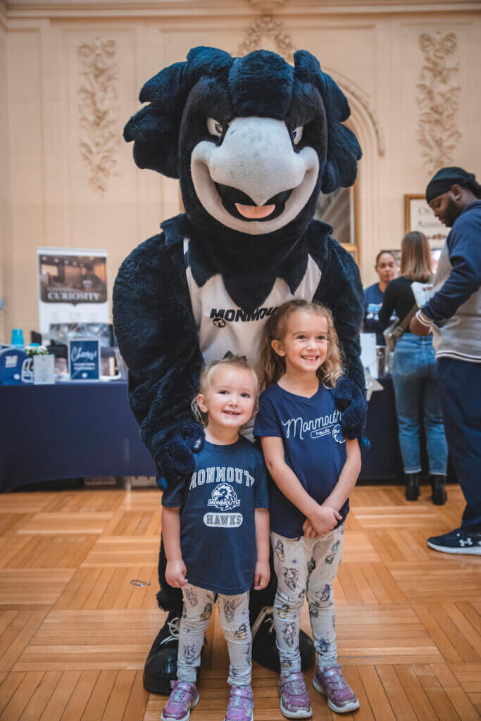 Shadow the Hawk posing with two children in the Great Hall