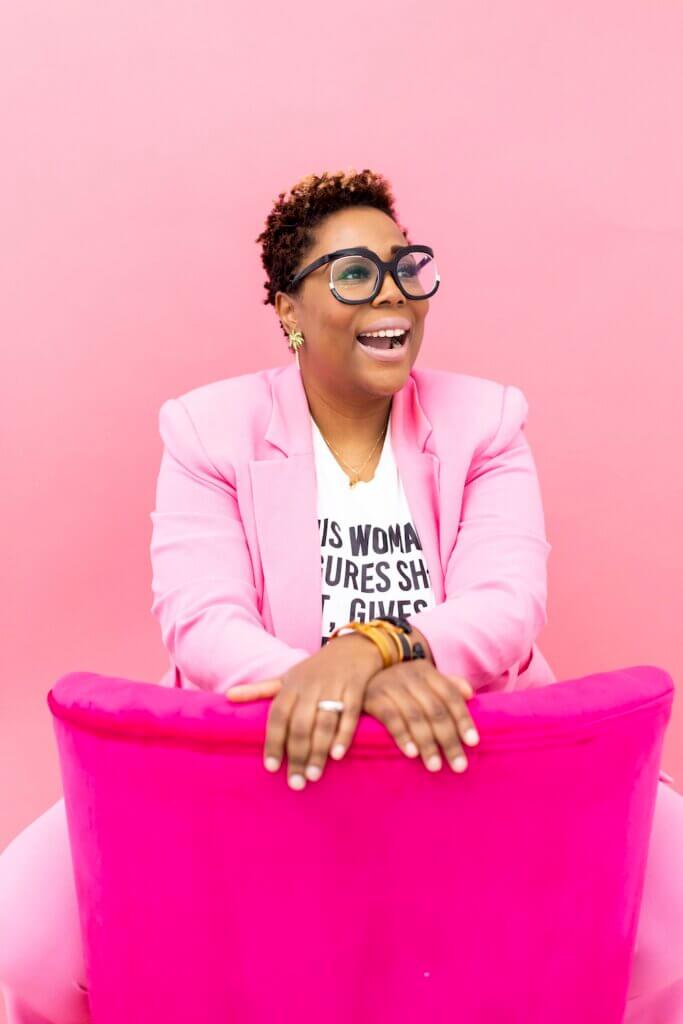 Photo of Kuree Cain sitting on a chair backwards