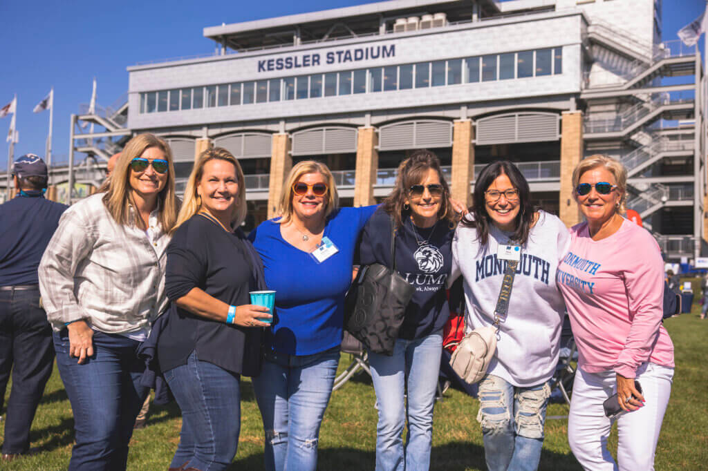 Group of women posing for photo in front of Kessler Stadium