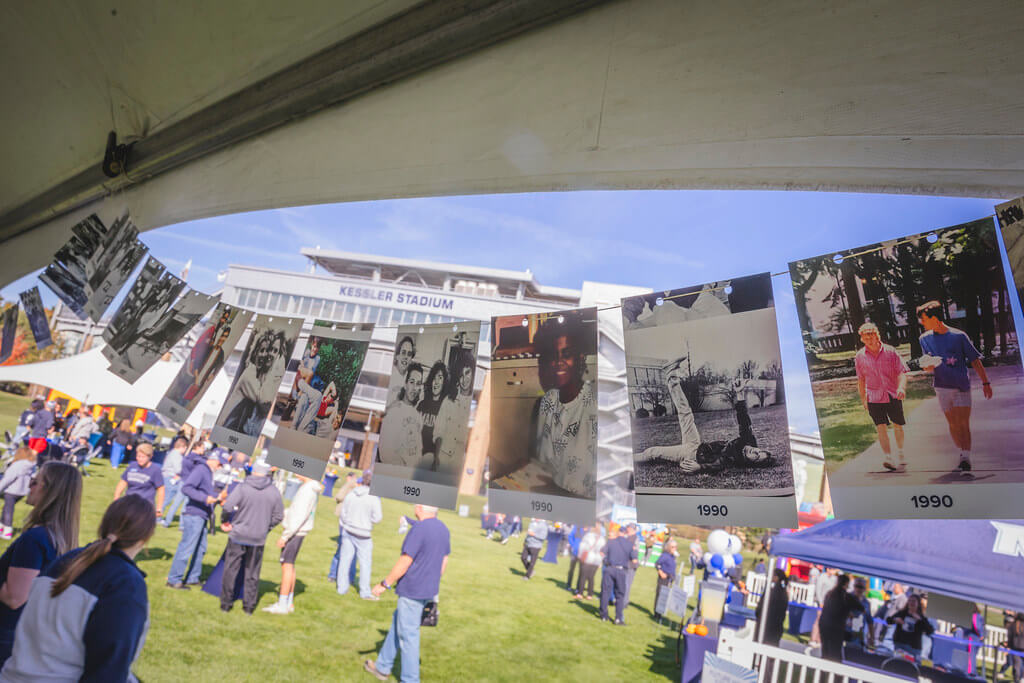 Photos strung up at the Milestone tent from 1990 with Kessler Stadium in the background