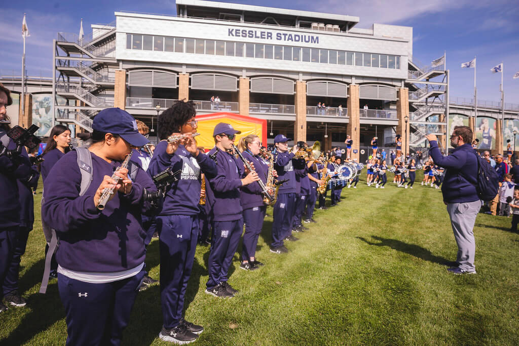 Monmouth Pep Band being directed by Jeff Cook in front of Kessler Stadium
