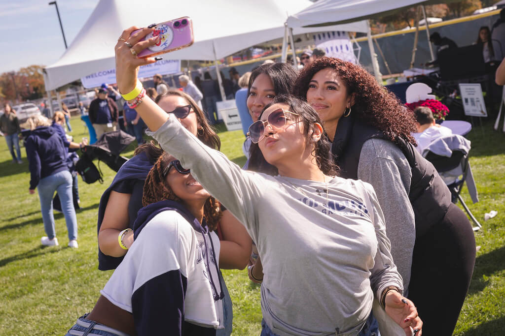 group of 5 young ladies posing and taking a selfie at the Homecoming Tailgate
