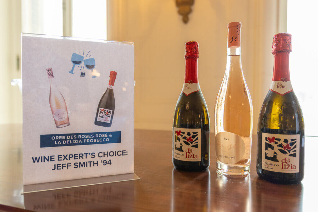 Three bottles of wine displayed beside a sign reading “Wine Expert’s Choice: Jeff Smith ’94."