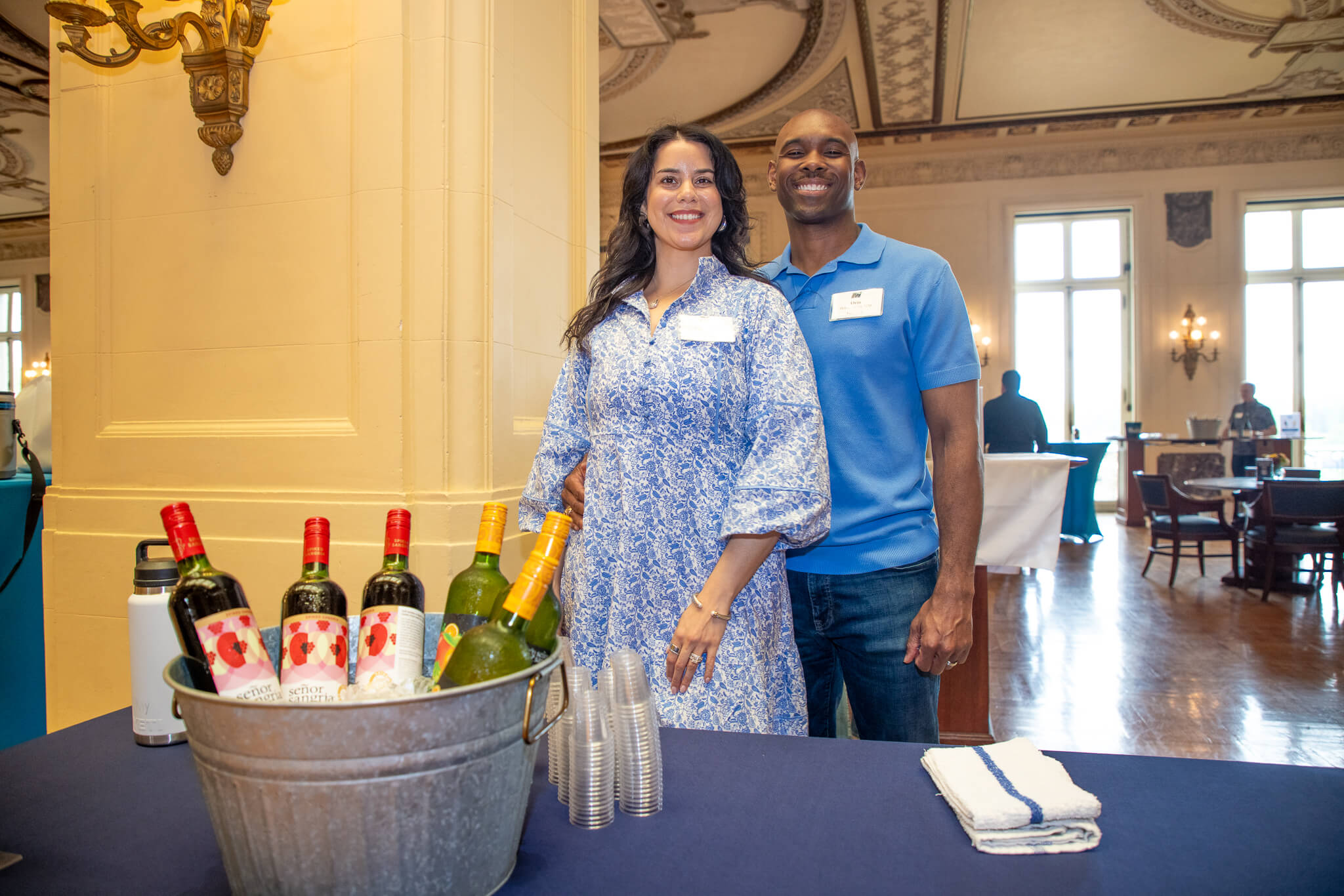 Monmouth University alumni smile for the camera with their drink of choice, Senior Sangria. 