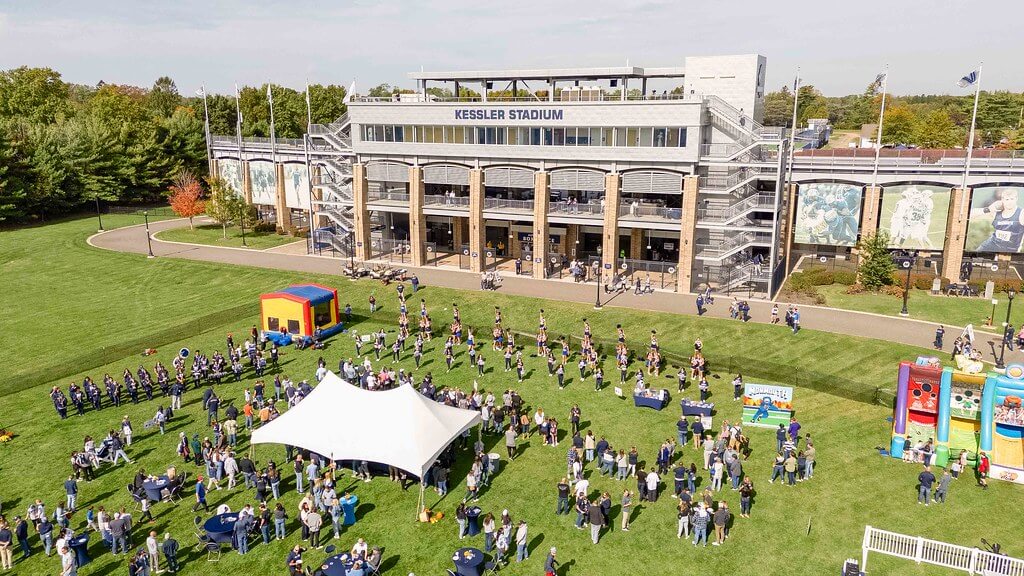 aerial photo of the Homecoming Tailgate displaing the tents, spirit squads performing, inflatables and Kessler Stadium