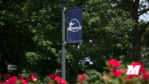 A banner featuring the Hawk's Head Monmouth University logo