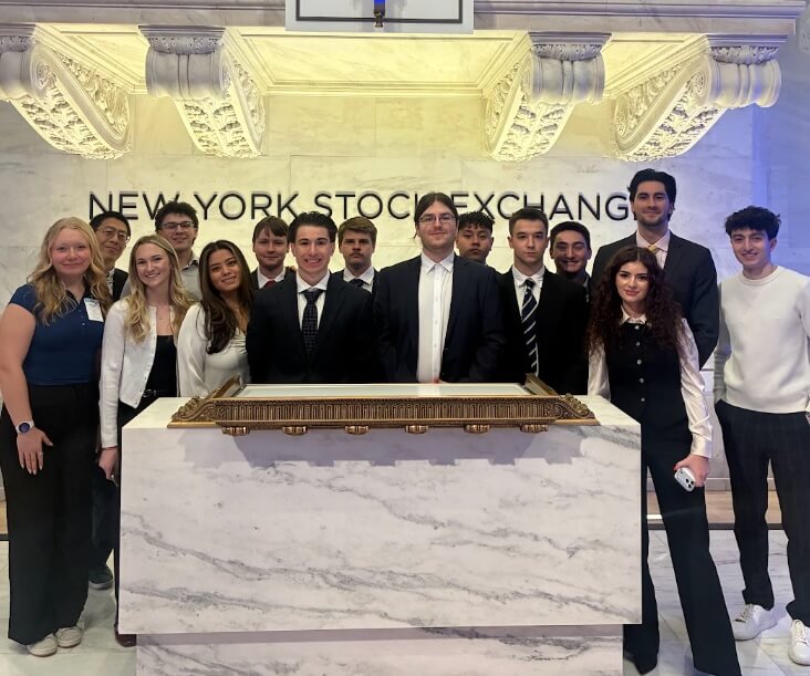 Students posing for a photo in the New York Stock Exchange.