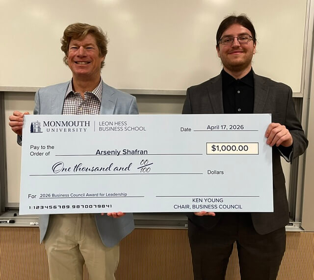 Two men holding an oversized check. The check is for $1,000, dated April 17, 2025, and awarded to Arseniy Shafran for the 2026 Business Council Award for Leadership. Its from Ken Young, Chair of the Business Council 