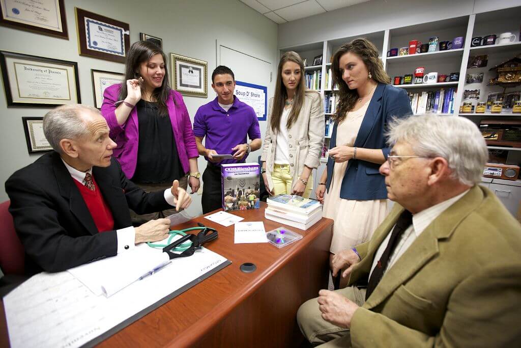 A group of people around a desk