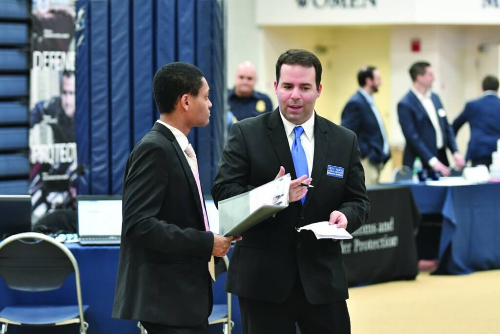 A Career Development counselor helps a student at the internship fair