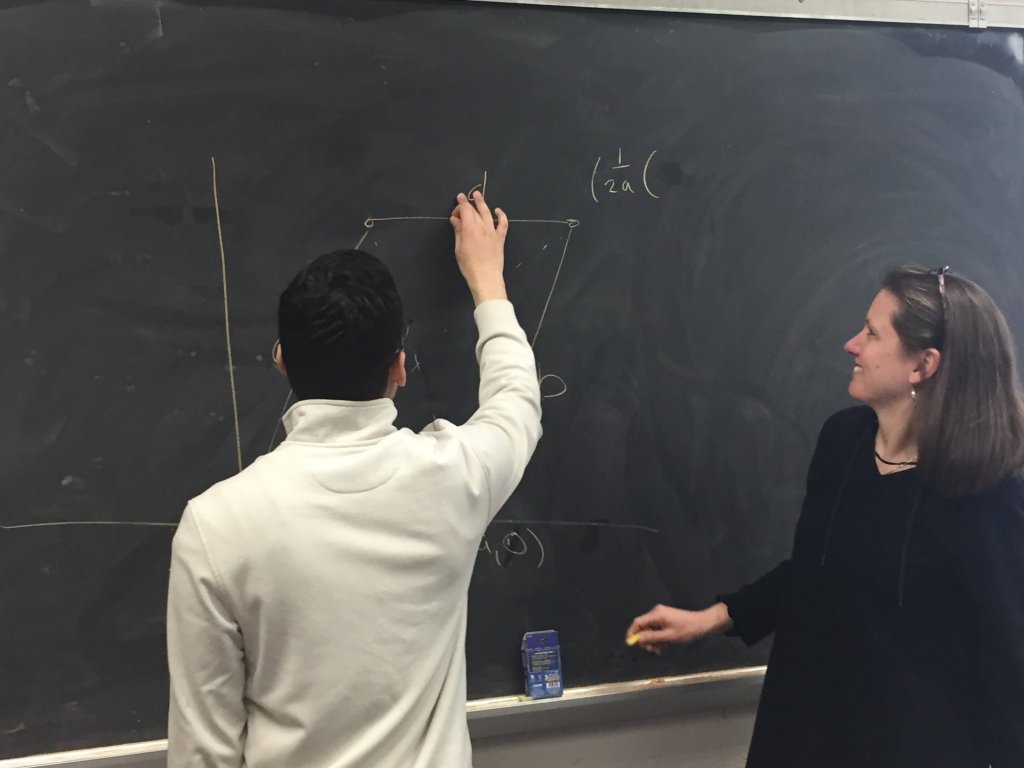 Student Nate Rodriguez and Dr. Susan Marshall tackle a math problem on the blackboard - Photo 4