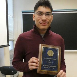 Photo of MU Senior Nathaniel Rodriguez with his Outstanding Scholarship in Mathematics award plaque