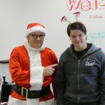 Photo of Santa with student who was the worst guess winner in the candy jar contest