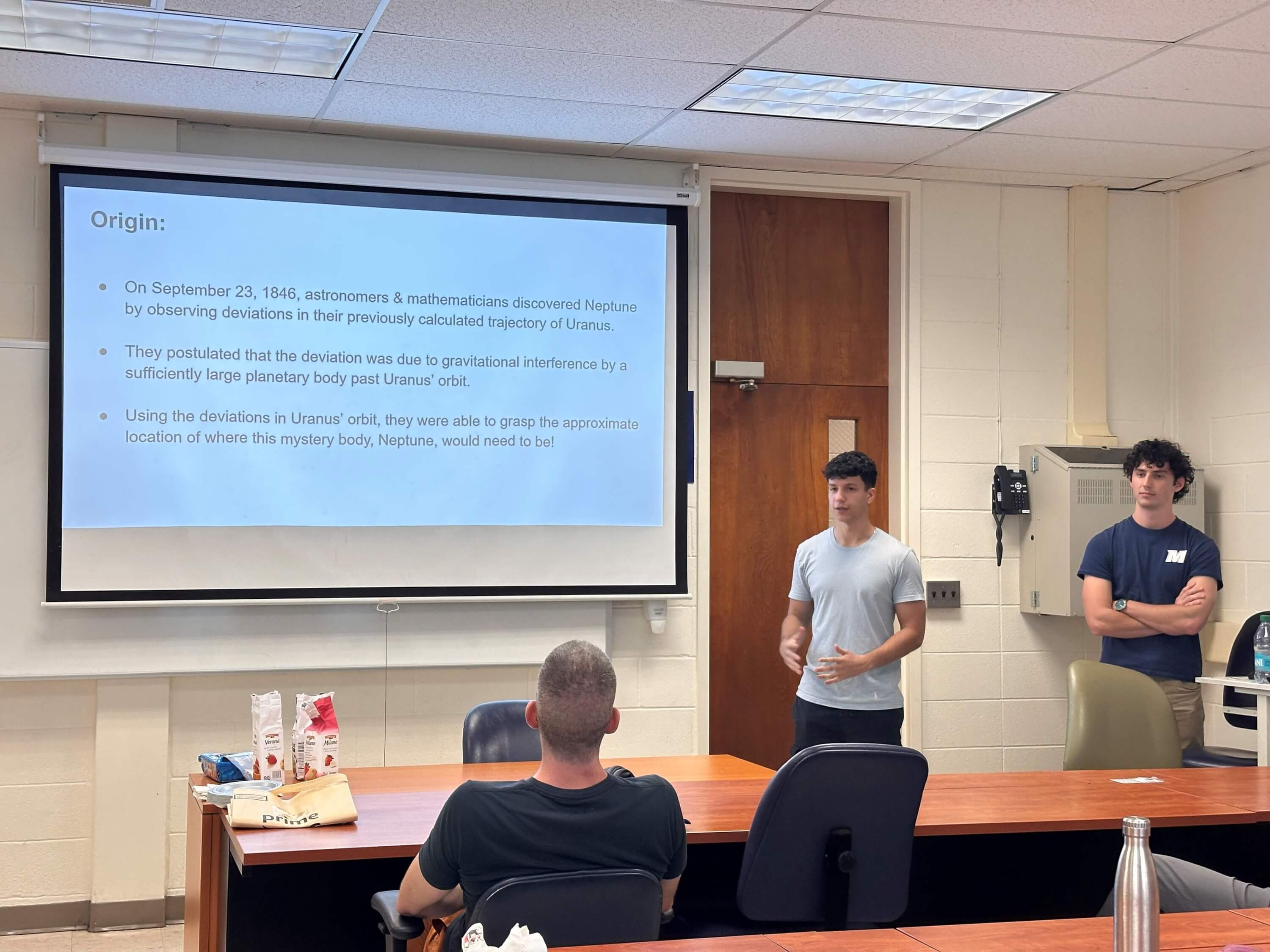 Two men speaking to audience about orbital deviations