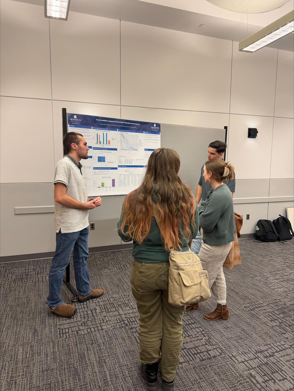 group of people observing poster presentation