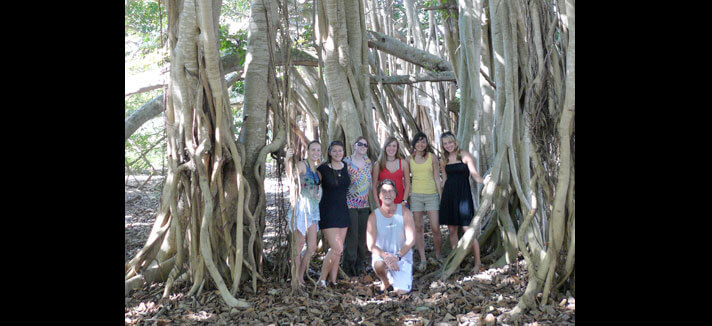 A group shot of students in front of trees