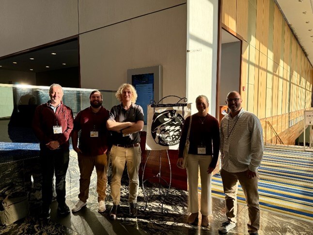 Professionals standing in front of an illustration