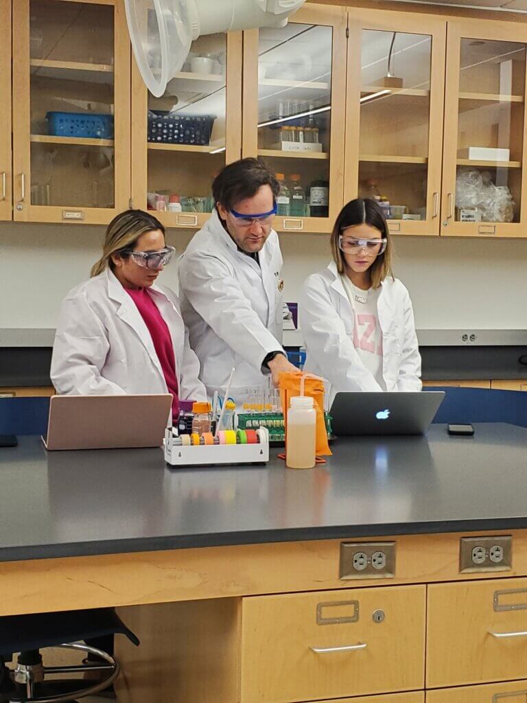 A man and two women making observations on their computers