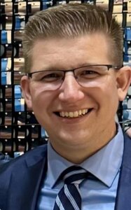 Man in business suit and glasses, smiling