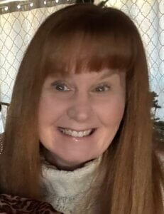 Woman in turtle-neck sweater smiling