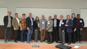 A photo of people standing in a line to celebrate the Monmouth University TECHPitch Event including Kalyna Reda