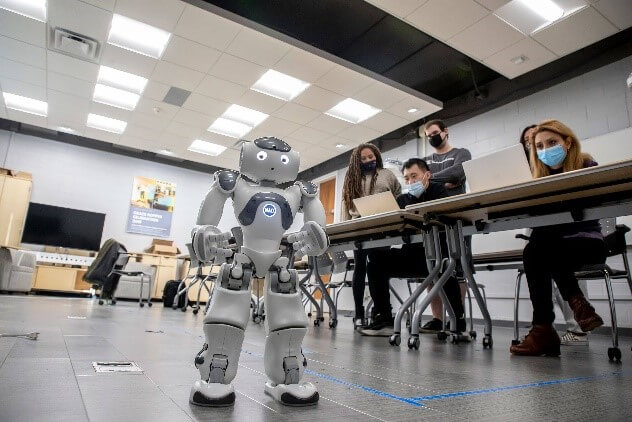 Students are programming a walking robot