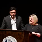 Photo of Professors Gilvarry and Swanson, co-advisors for the Delta Sigma Chapter, welcoming new members, family and friends during Induction Ceremony
