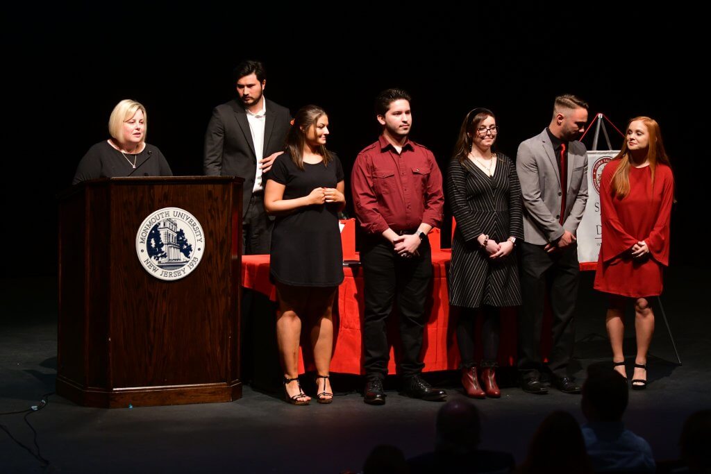 Photo shows student award recipients on stage