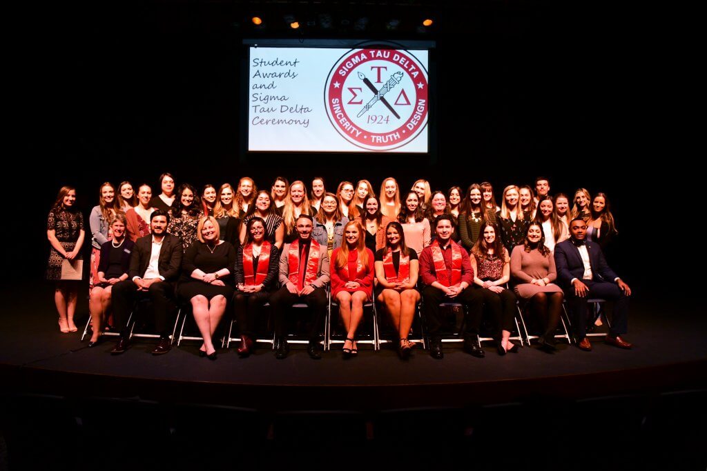 Photo shows English Student Awards Recipients and Fall 2018/Spring 2019 Inductees gathered on stage