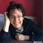 Poet smiling, resting cheek on hand