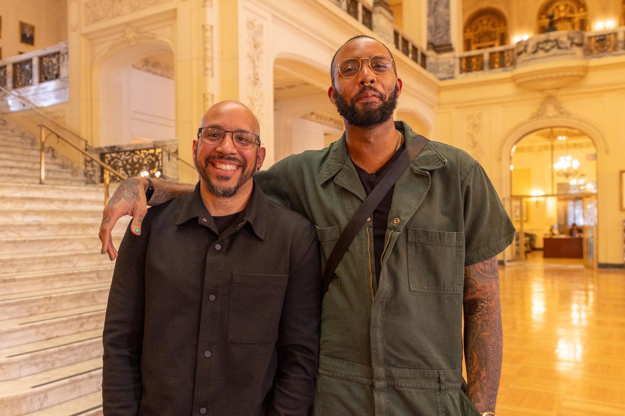 Two men, one with arm over the other's shoulder