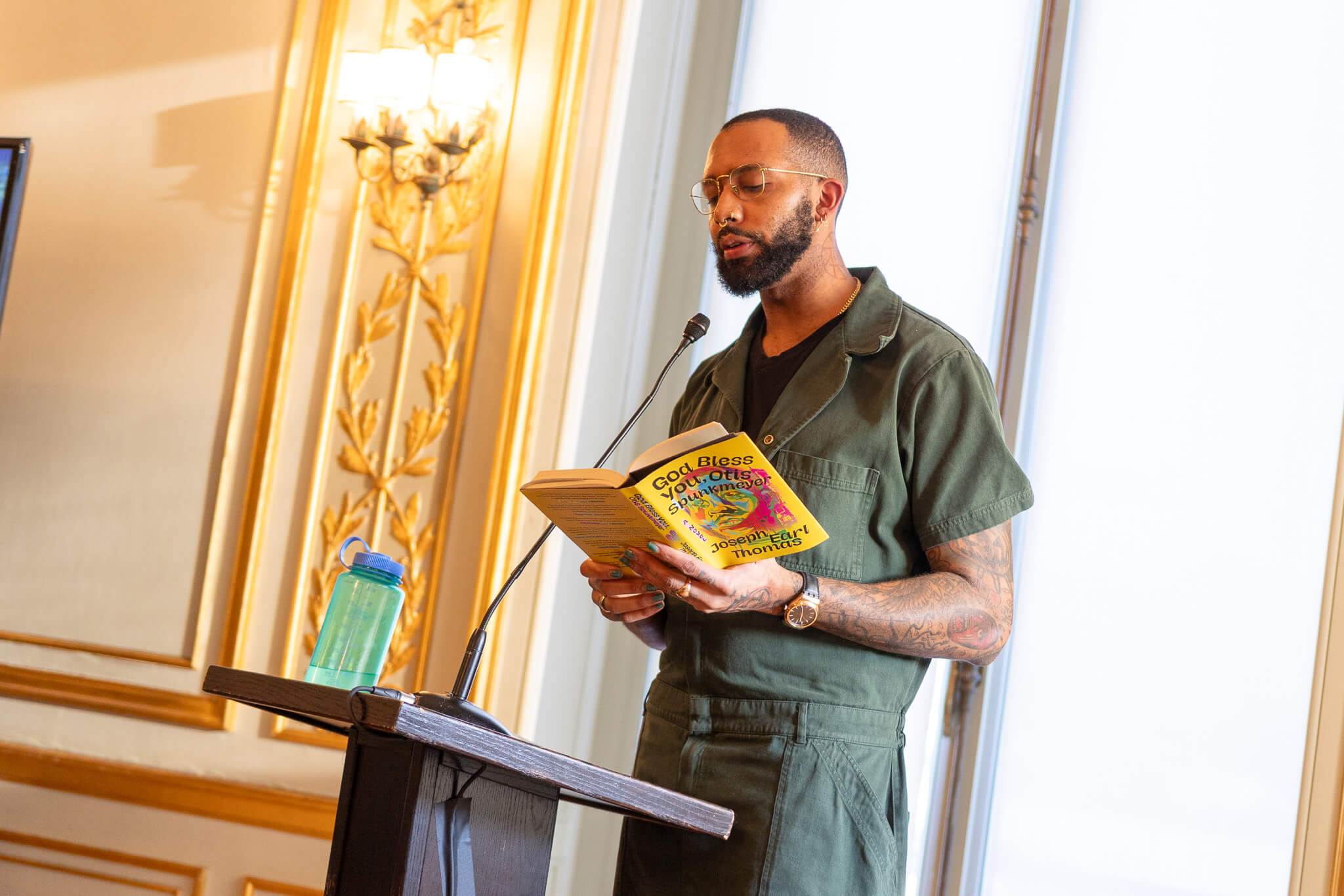 Man reading book at podium