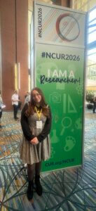 Woman near banner reading "I am a researcher"