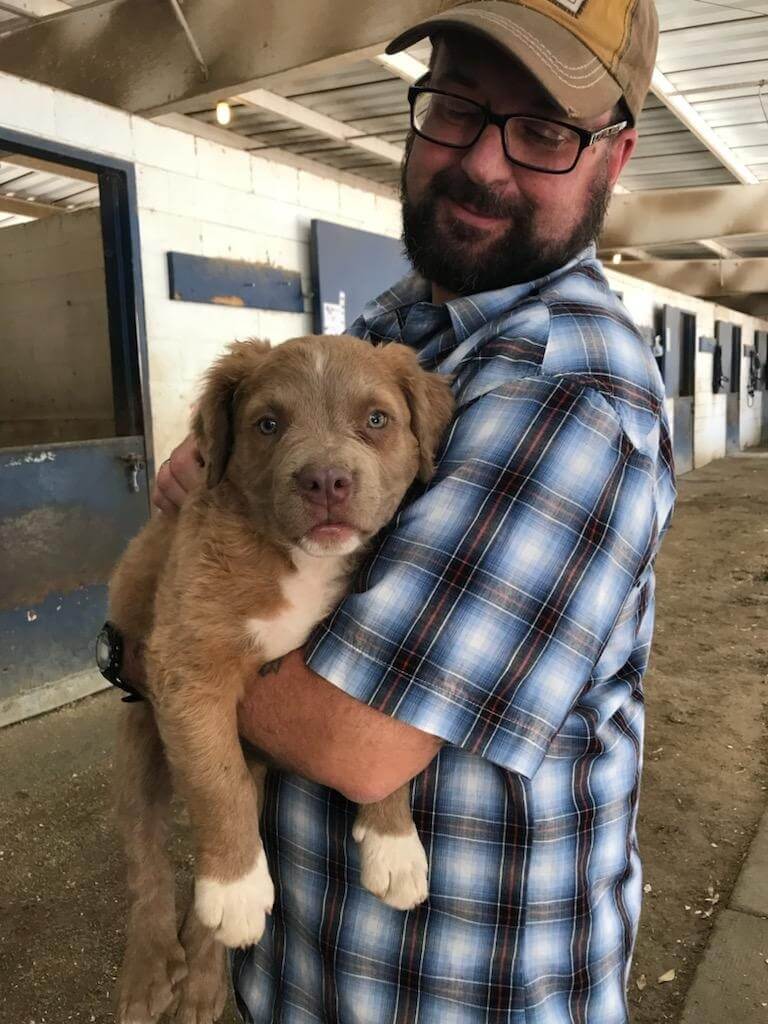 Man holding a dog in his arms