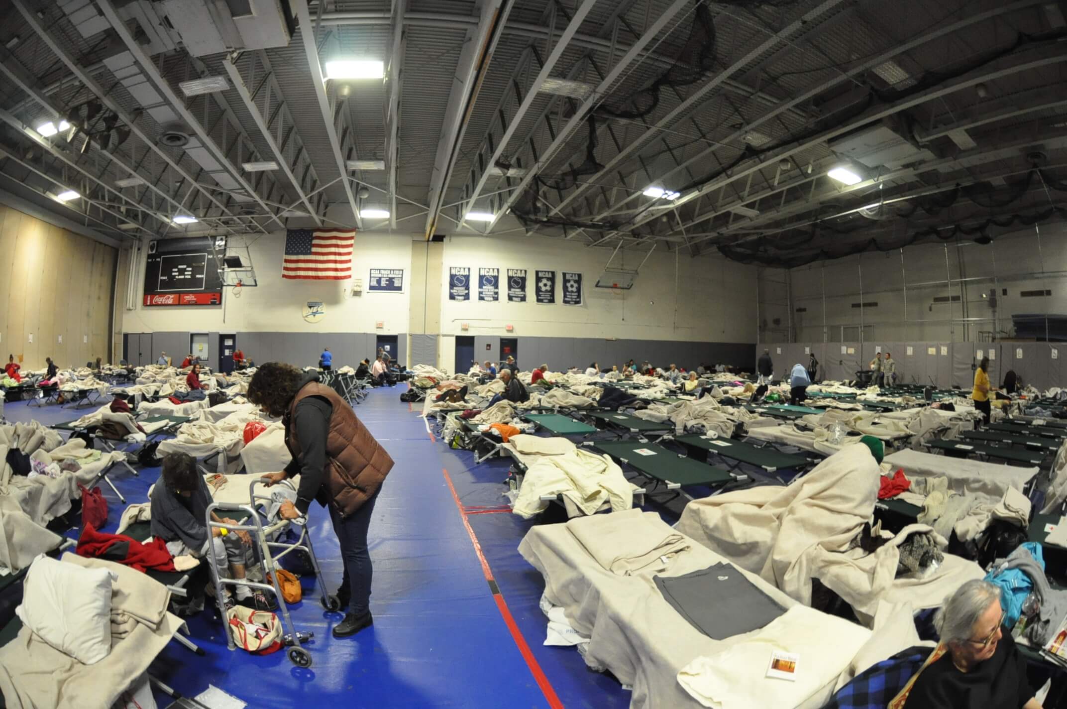 Photo of cots and people staying at the MAC during Superstorm Sandy