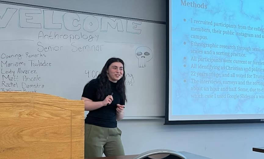Student smiling while delivering presentation