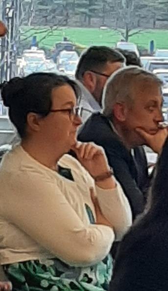 Audience members listening to a presentation