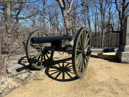 A antiquated cannon on two large wheels