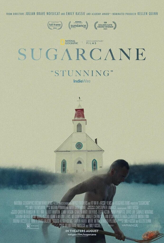 Poster for the film "Sugarcane", showing a man with a pitchfork holding a hot coal, an old school looming in the background.