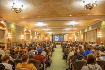 Audience in hall watching a presentation