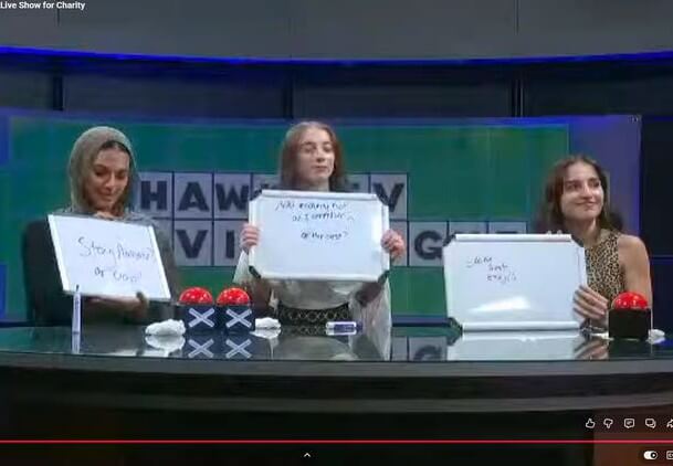 Contestants holding up whiteboards, their answers to Final Jeopardy written on the boards