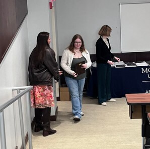 Student walking with award plaque